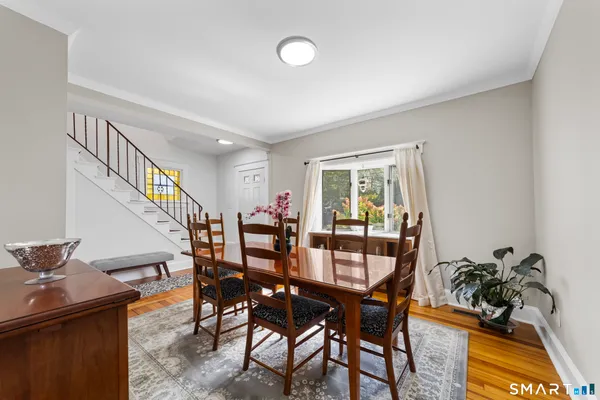a view of a dining room with furniture and a window