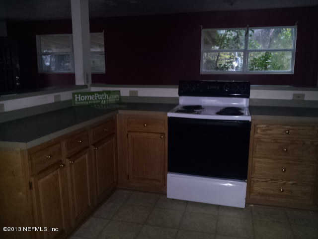 720 Bonita Road Atlantic Beach, FL 32233 - Photo 4 of 12 a kitchen with stainless steel appliances a stove and a microwave oven
