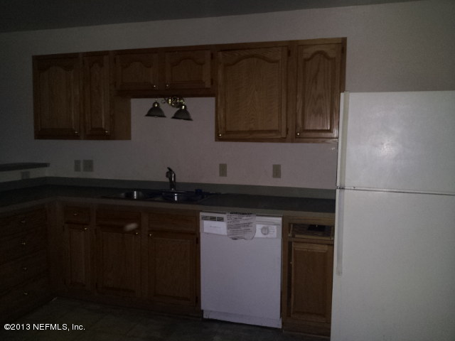 720 Bonita Road Atlantic Beach, FL 32233 - Photo 5 of 12 a kitchen with a sink and a microwave