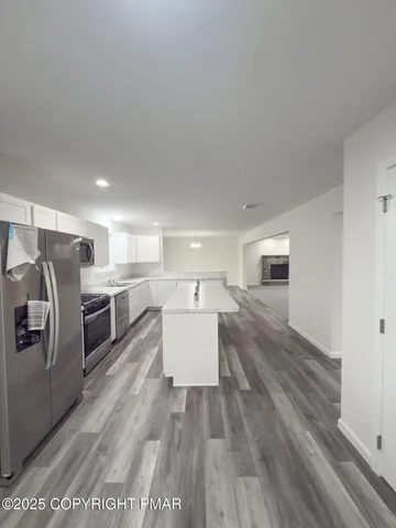 a kitchen with stainless steel appliances a refrigerator a sink dishwasher stove and oven