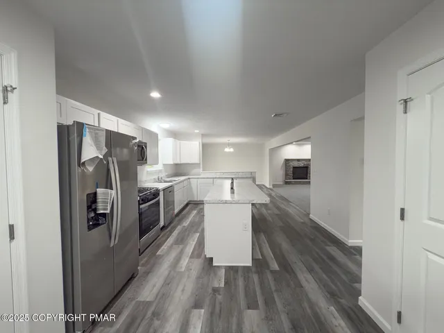 a kitchen with a refrigerator and a sink