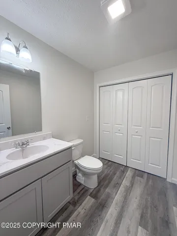 a bathroom with a sink toilet and vanity