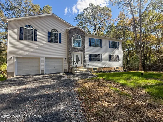 a front view of a house with a yard and garage