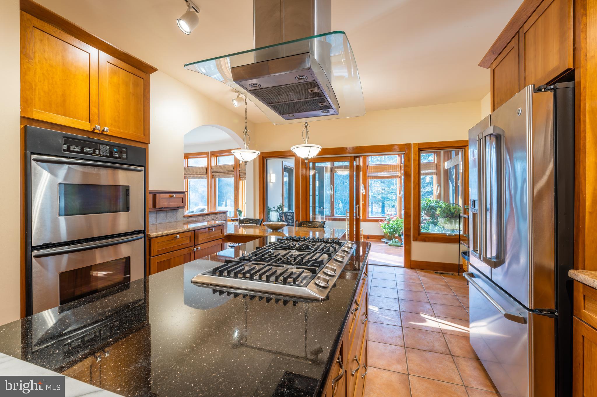 965 Curtis Road Solomons, MD 20629 - Photo 16 of 47 a kitchen with stainless steel appliances granite countertop a stove and a refrigerator