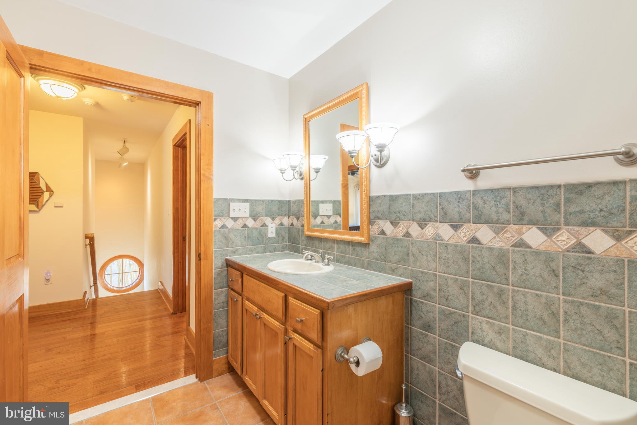 965 Curtis Road Solomons, MD 20629 - Photo 31 of 47 a bathroom with a sink and a mirror