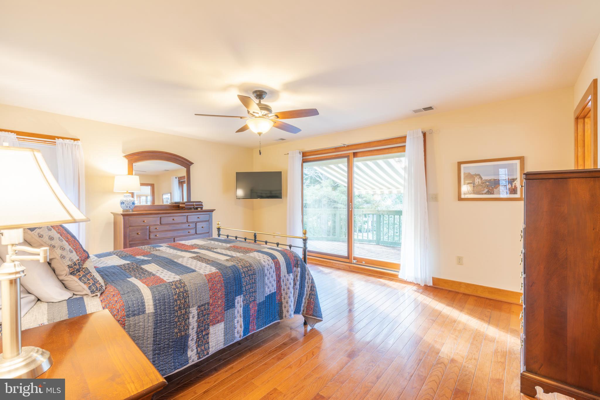 965 Curtis Road Solomons, MD 20629 - Photo 32 of 47 a bedroom with a large bed and a large window