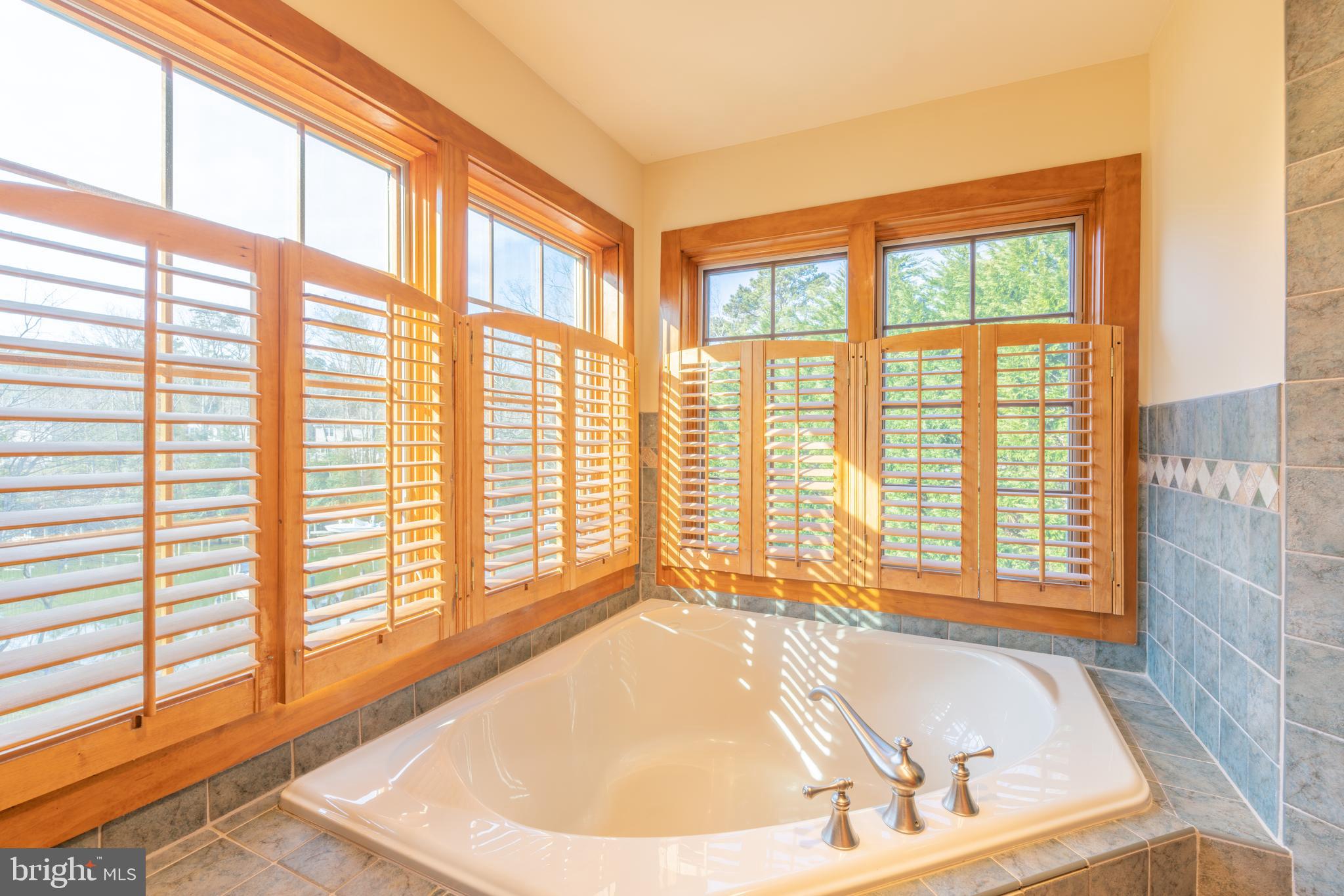 965 Curtis Road Solomons, MD 20629 - Photo 37 of 47 a white bath tub sitting in a bathroom next to a window