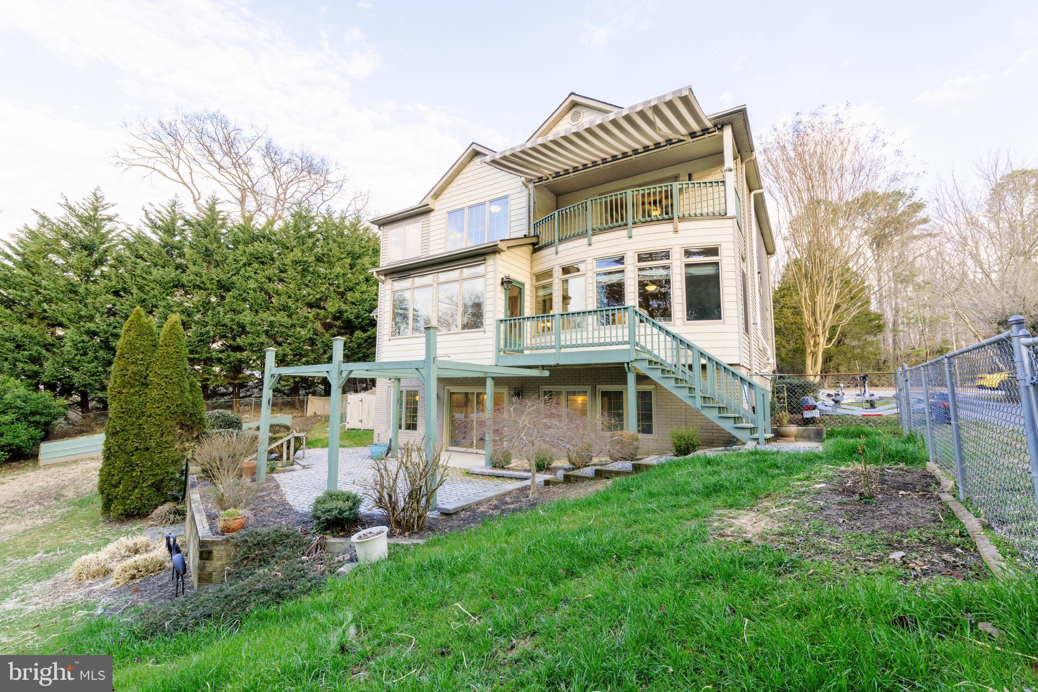 965 Curtis Road Solomons, MD 20629 - Photo 46 of 47 a front view of a house with a yard table and chairs