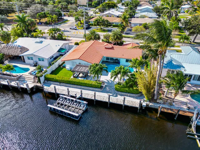 an aerial view of a house with swimming pool and outdoor seating
