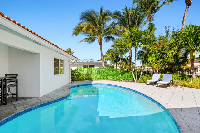 a view of a swimming pool with a lounge chair