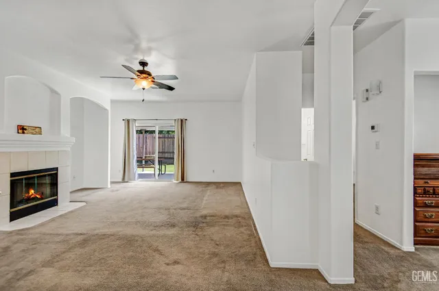 a view of an empty room with a fireplace