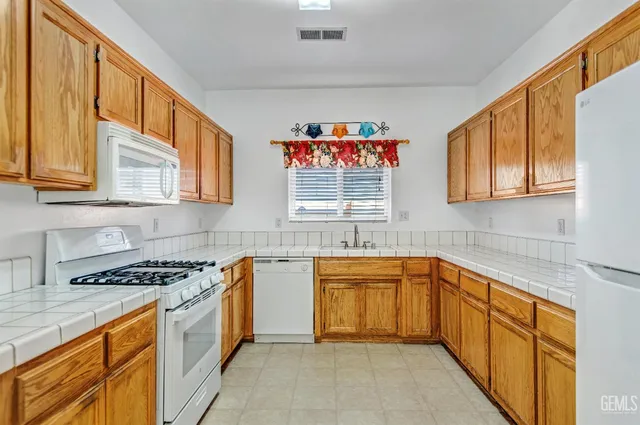 a kitchen with stainless steel appliances granite countertop a sink and cabinets