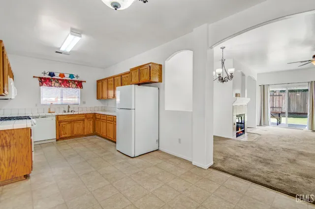 a view of a kitchen with a sink and a refrigerator