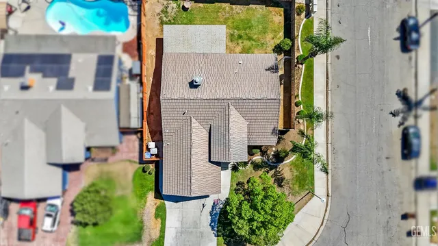 a aerial view of a house with a yard and potted plants
