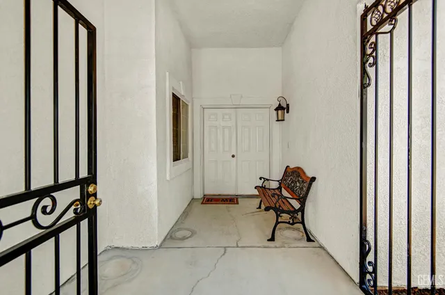 a view of a hallway with furniture and a window