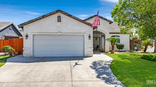 a front view of house with yard and green space