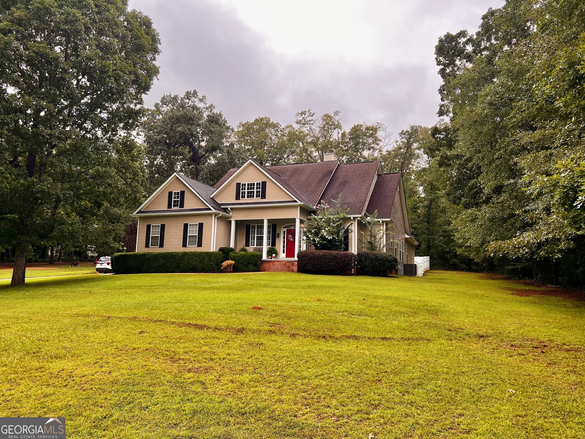 a front view of a house with yard and swimming pool