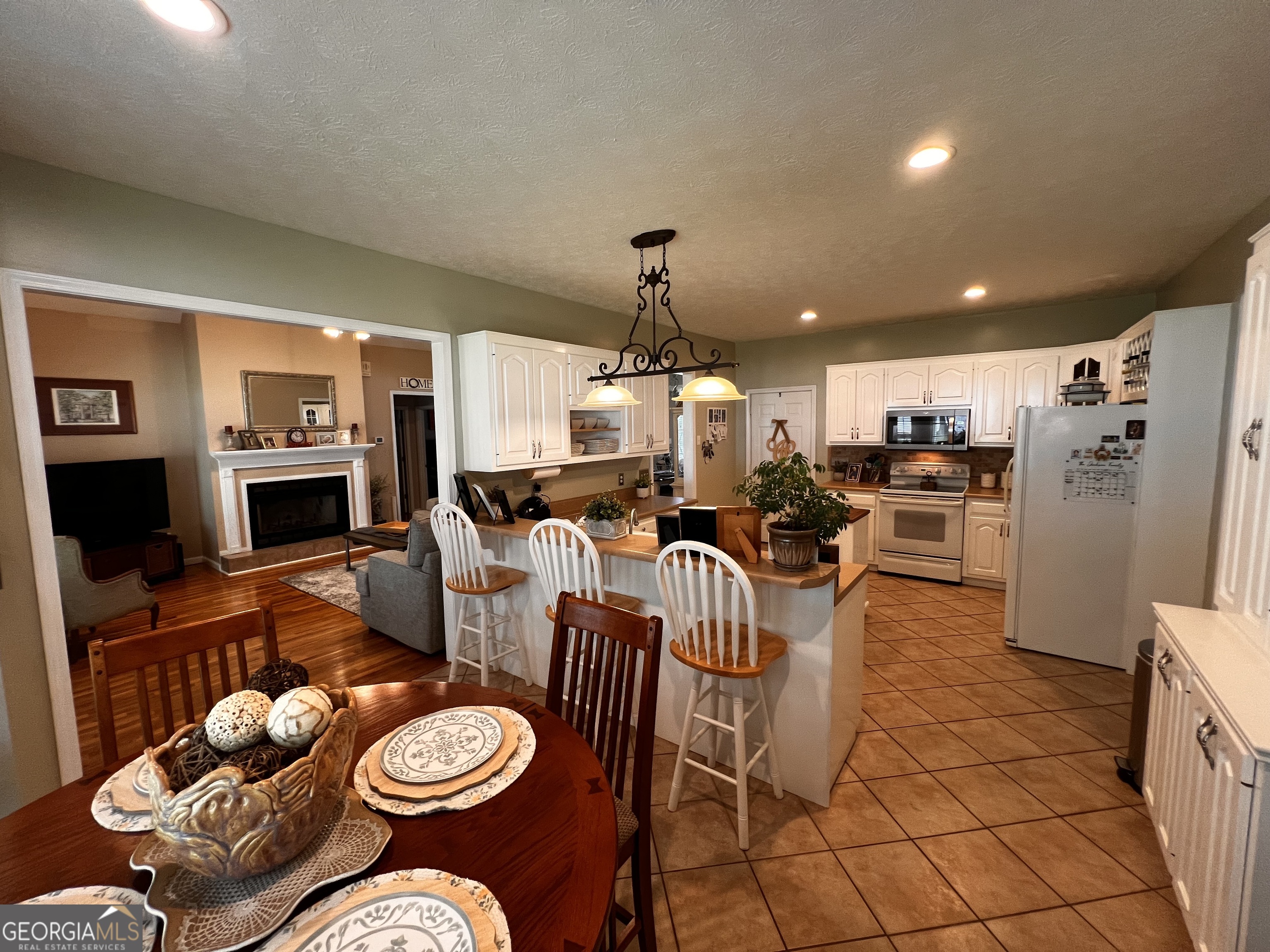 410 Irvin Road Thomaston, GA 30286 - Photo 15 of 42 a living room with furniture a fireplace and a flat screen tv