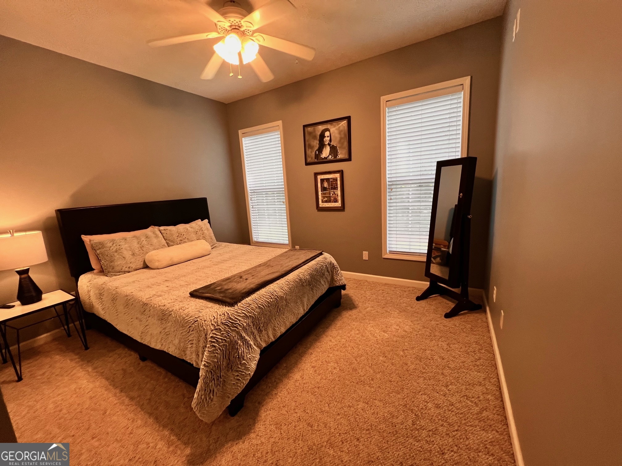 410 Irvin Road Thomaston, GA 30286 - Photo 28 of 42 a bedroom with a bed and a chandelier