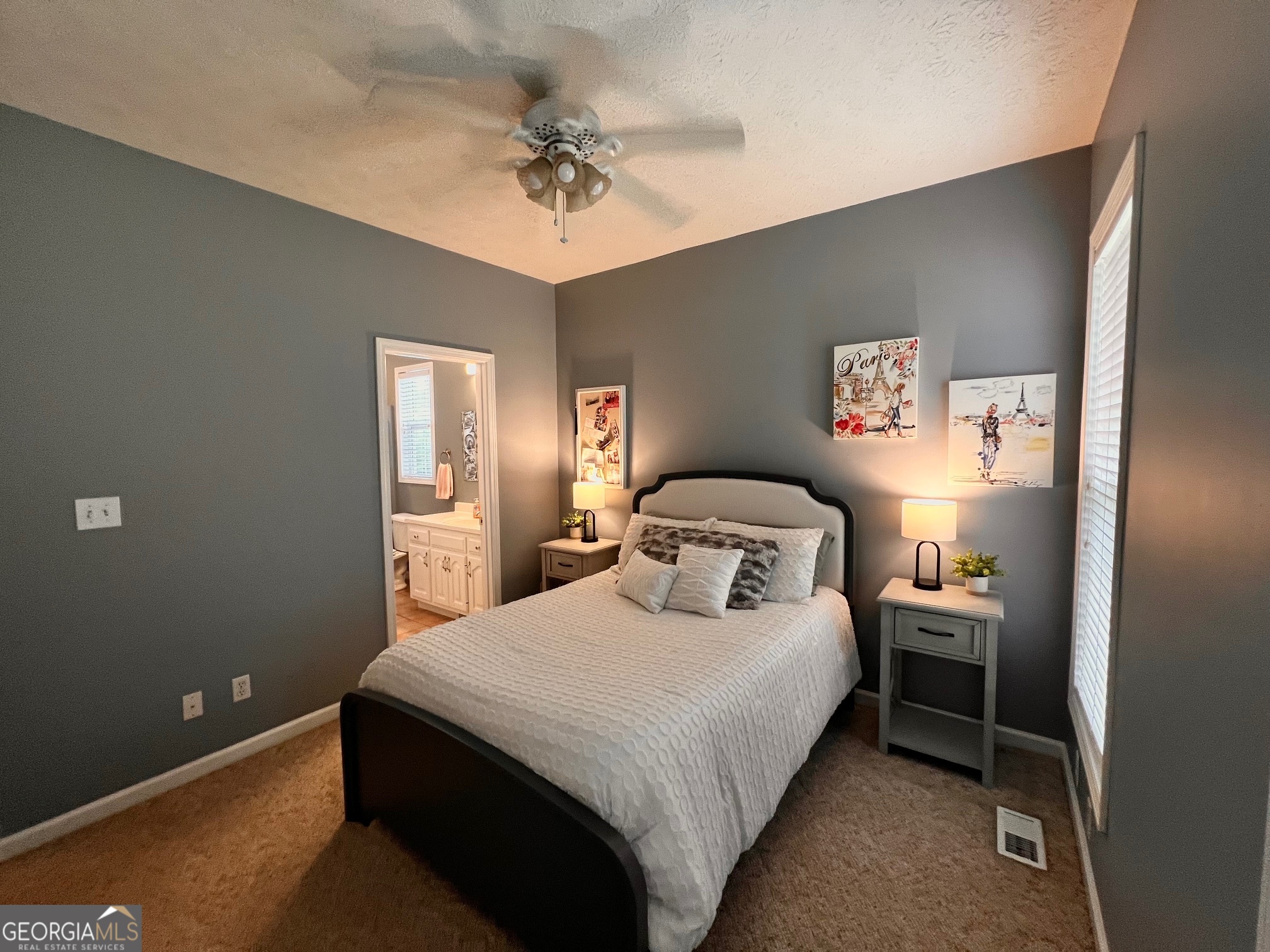 410 Irvin Road Thomaston, GA 30286 - Photo 31 of 42 a bedroom with a bed and a chandelier