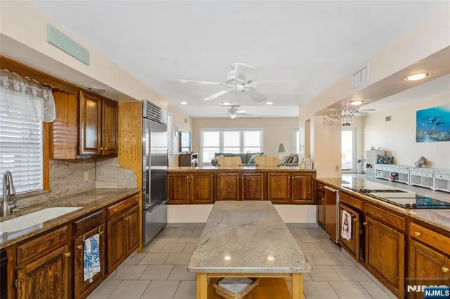 a large kitchen with stainless steel appliances lots of counter space and a sink