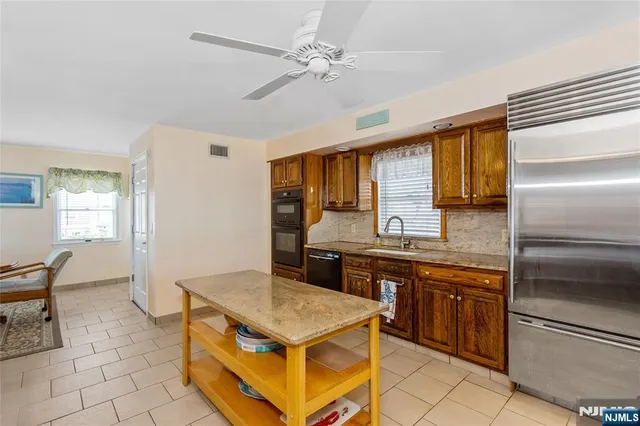 a kitchen with a stove a sink and a refrigerator