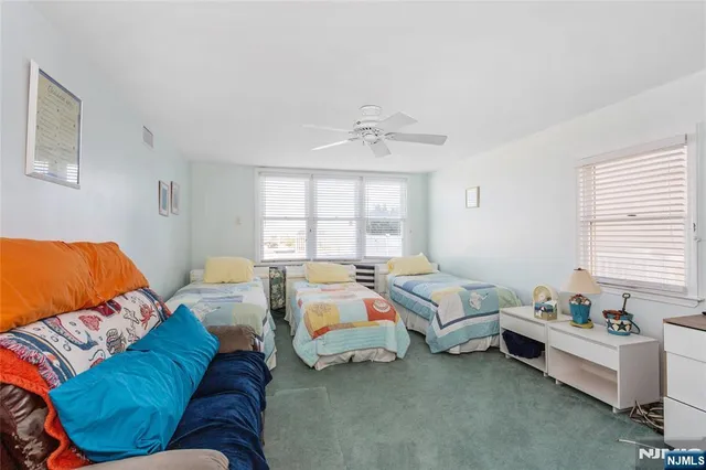 a bedroom with furniture and a large window
