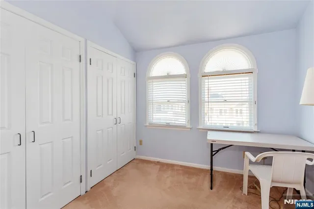 a view of room with windows and fan