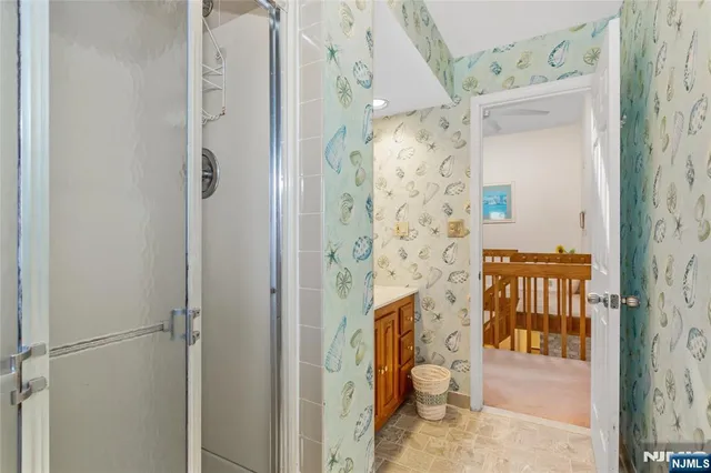 a bathroom with a granite countertop shower and a sink
