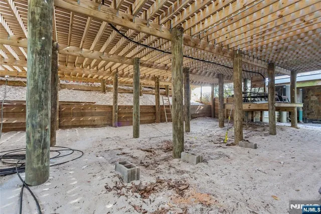 a view of a porch with a table chairs and wooden fence