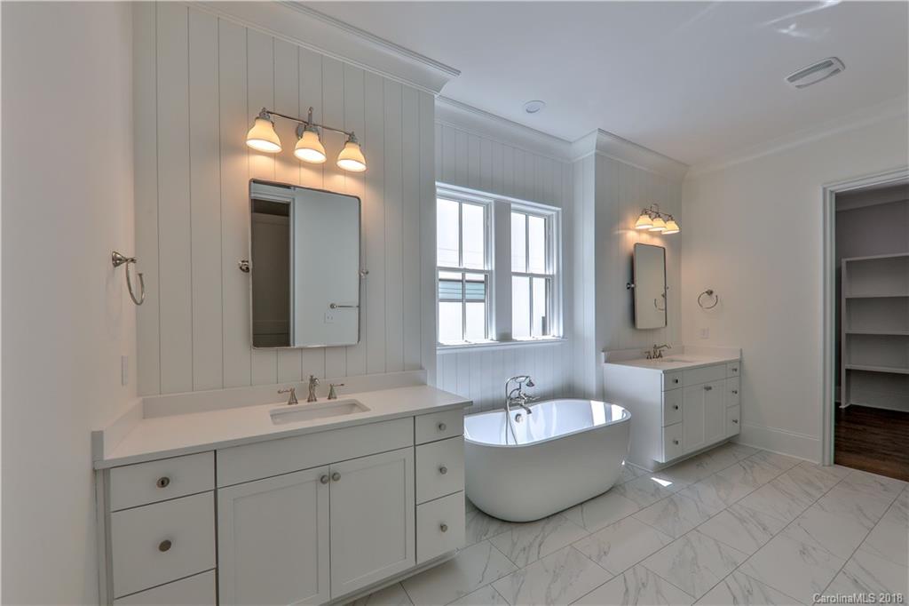 724 Ellsworth Road Charlotte, NC 28211 - Photo 15 of 33 a bathroom with double vanity sink a bathtub and mirrors