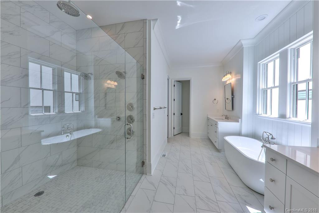 724 Ellsworth Road Charlotte, NC 28211 - Photo 16 of 33 a bathroom with a granite countertop sink a toilet a shower and a mirror