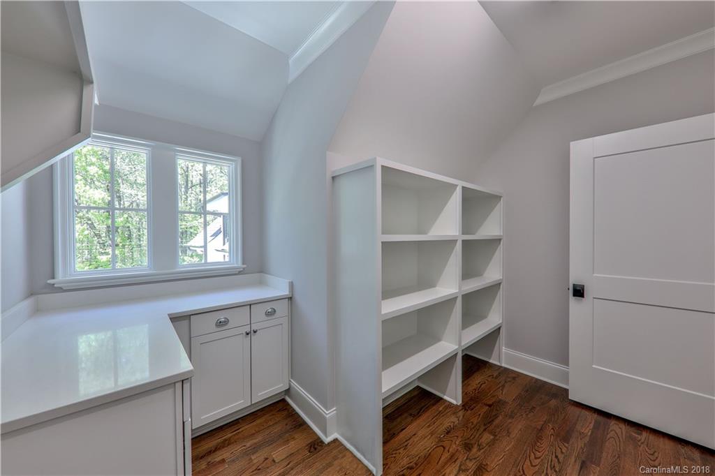 724 Ellsworth Road Charlotte, NC 28211 - Photo 20 of 33 a view of an empty room with a window and wooden floor