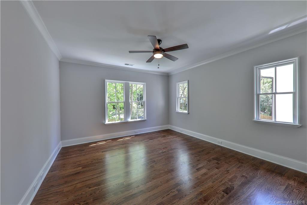 724 Ellsworth Road Charlotte, NC 28211 - Photo 24 of 33 a view of empty room with wooden floor and fan