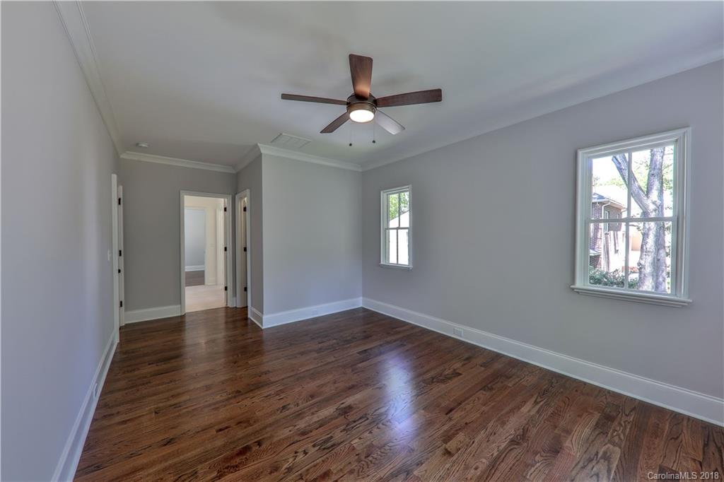 724 Ellsworth Road Charlotte, NC 28211 - Photo 26 of 33 a view of an empty room with wooden floor and a window