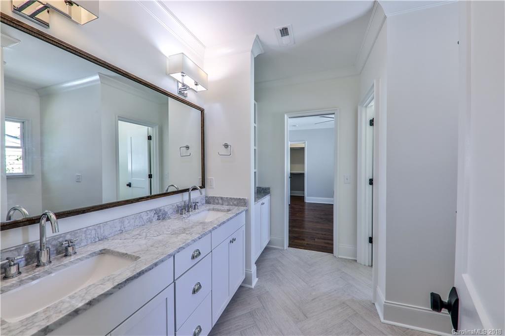 724 Ellsworth Road Charlotte, NC 28211 - Photo 27 of 33 a spacious bathroom with a granite countertop sink and a mirror