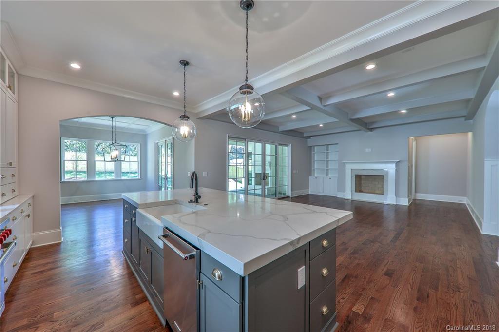 724 Ellsworth Road Charlotte, NC 28211 - Photo 5 of 33 a view of a kitchen island a chandelier and wooden floor