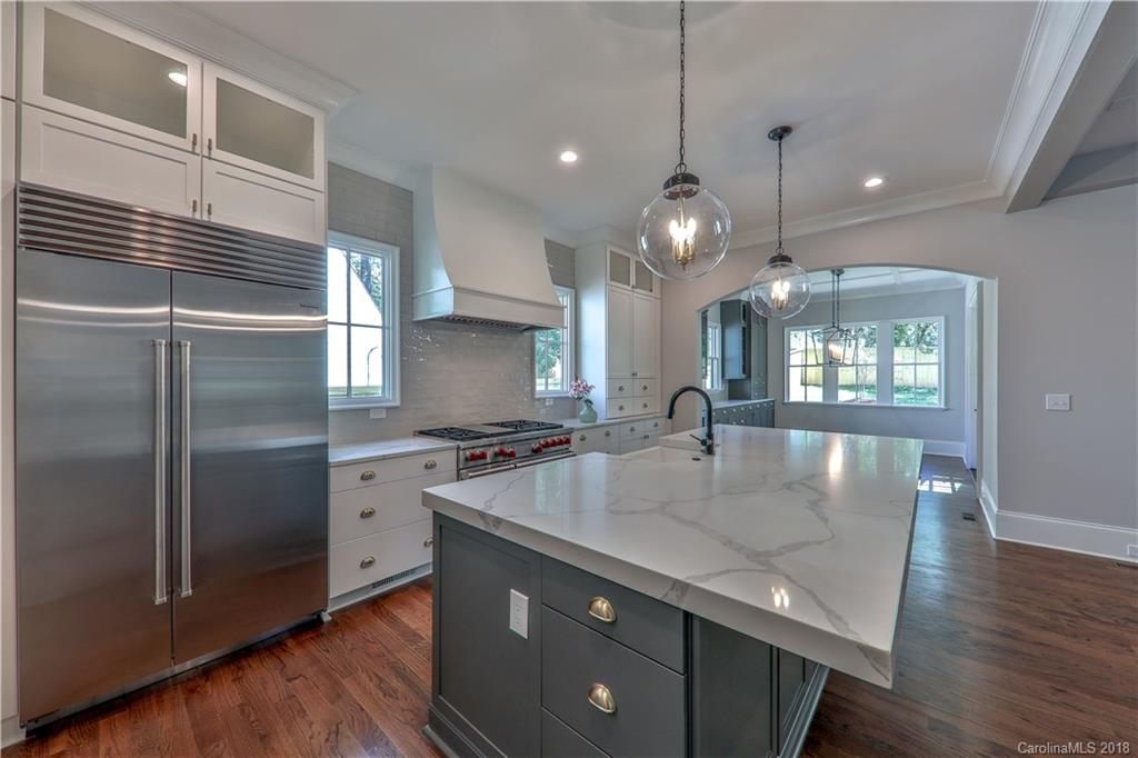 724 Ellsworth Road Charlotte, NC 28211 - Photo 6 of 33 a kitchen with stainless steel appliances granite countertop a sink a stove and a refrigerator