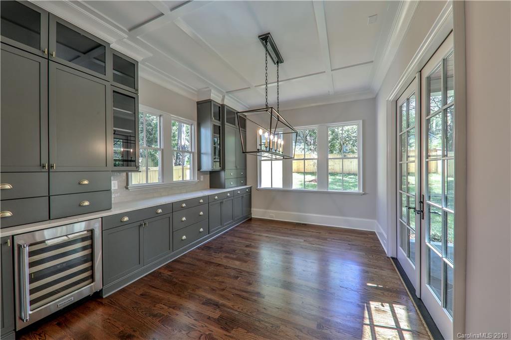 724 Ellsworth Road Charlotte, NC 28211 - Photo 8 of 33 a large kitchen with granite countertop a large window and wooden floor