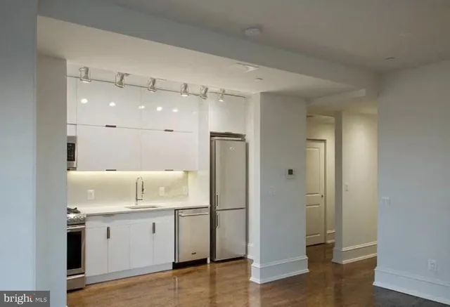 a bathroom with a shower sink and mirror
