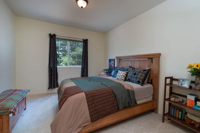 a bedroom with a bed and a window