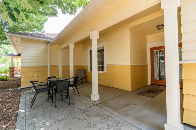 a view of a house with backyard and sitting area