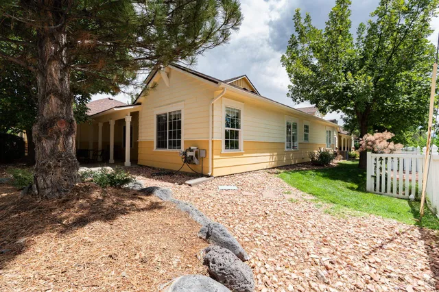 a view of a house with backyard and sitting area