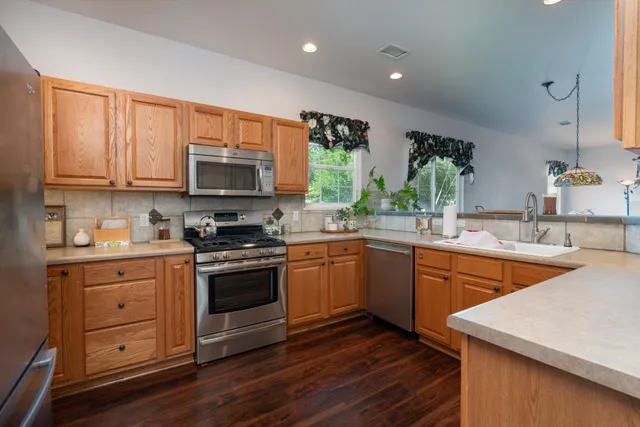 a kitchen with sink cabinets and wooden floor