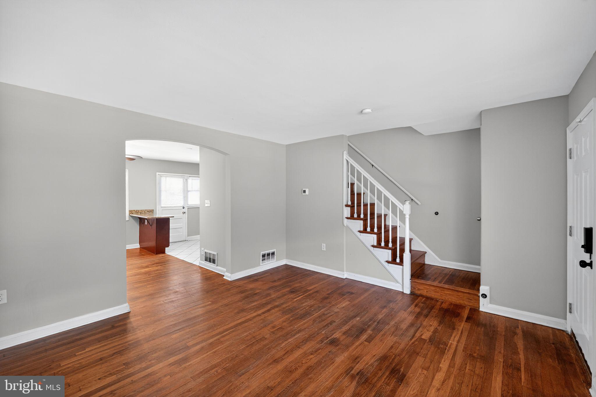 3125 Vulcan Road Dundalk, MD 21222 - Photo 11 of 33 a view of an empty room with wooden floor and a window