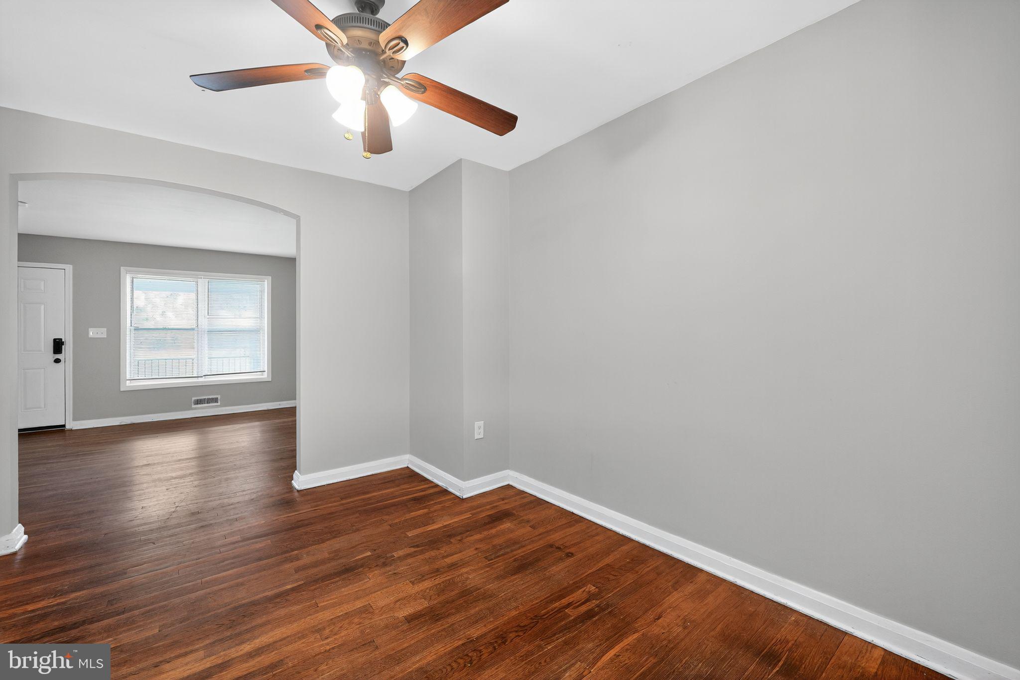 3125 Vulcan Road Dundalk, MD 21222 - Photo 13 of 33 a view of empty room with wooden floor and fan