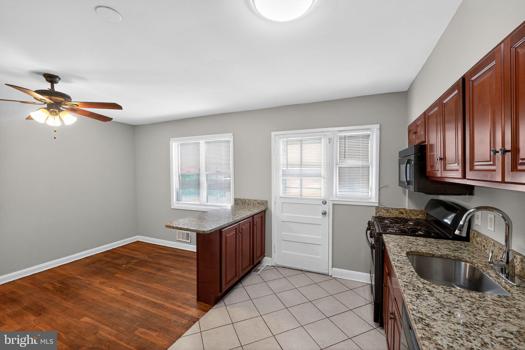 3125 Vulcan Road Dundalk, MD 21222 - Photo 15 of 33 a kitchen with stainless steel appliances granite countertop a sink stove and cabinets