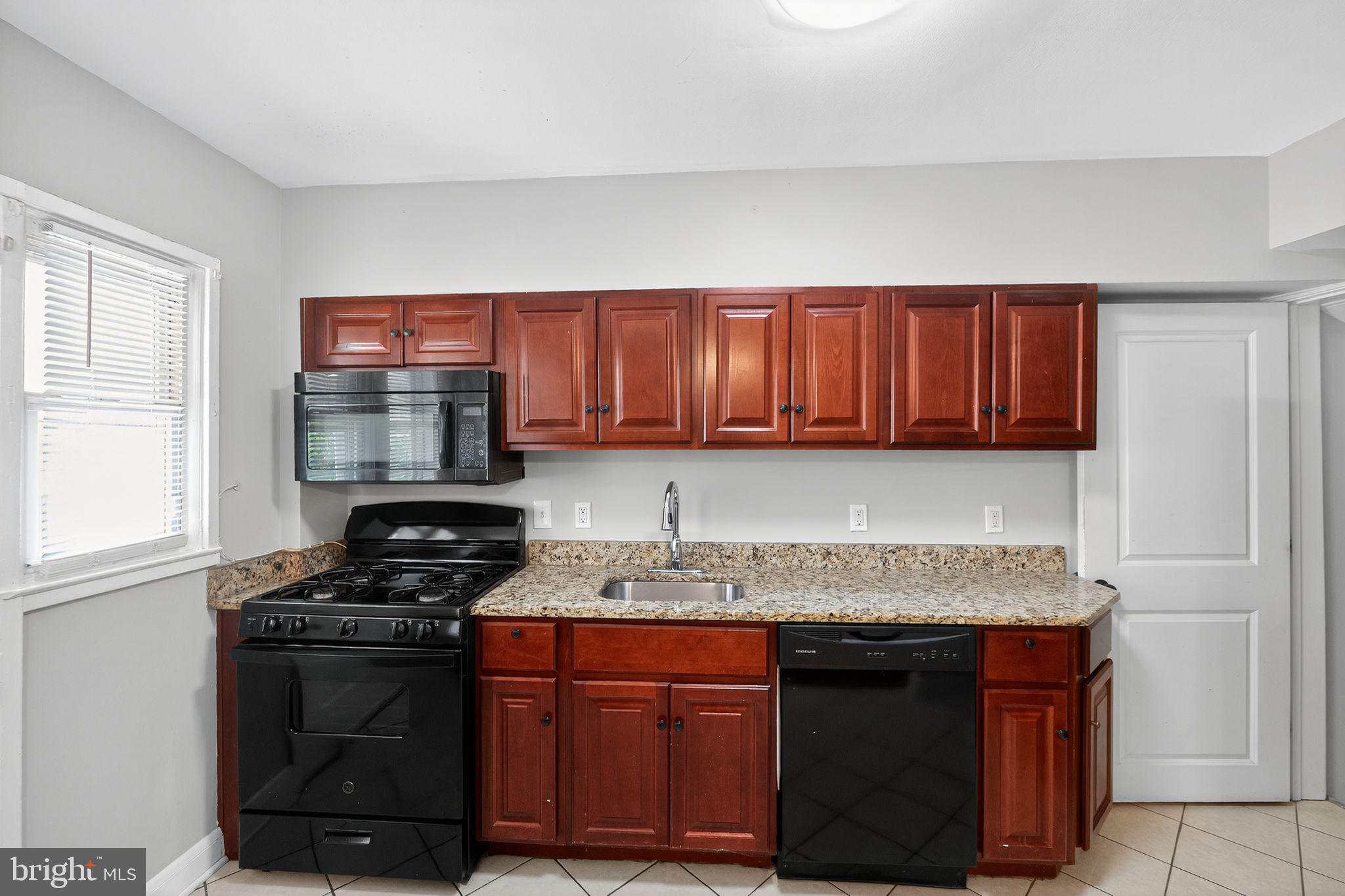 3125 Vulcan Road Dundalk, MD 21222 - Photo 17 of 33 a kitchen with stainless steel appliances granite countertop a stove a sink and a microwave