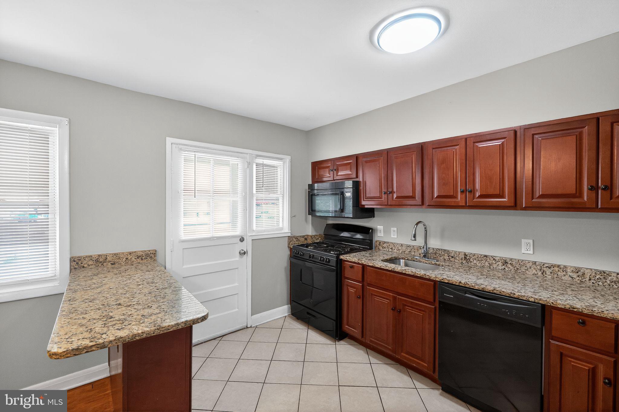 3125 Vulcan Road Dundalk, MD 21222 - Photo 18 of 33 a kitchen with stainless steel appliances granite countertop refrigerator sink and cabinets
