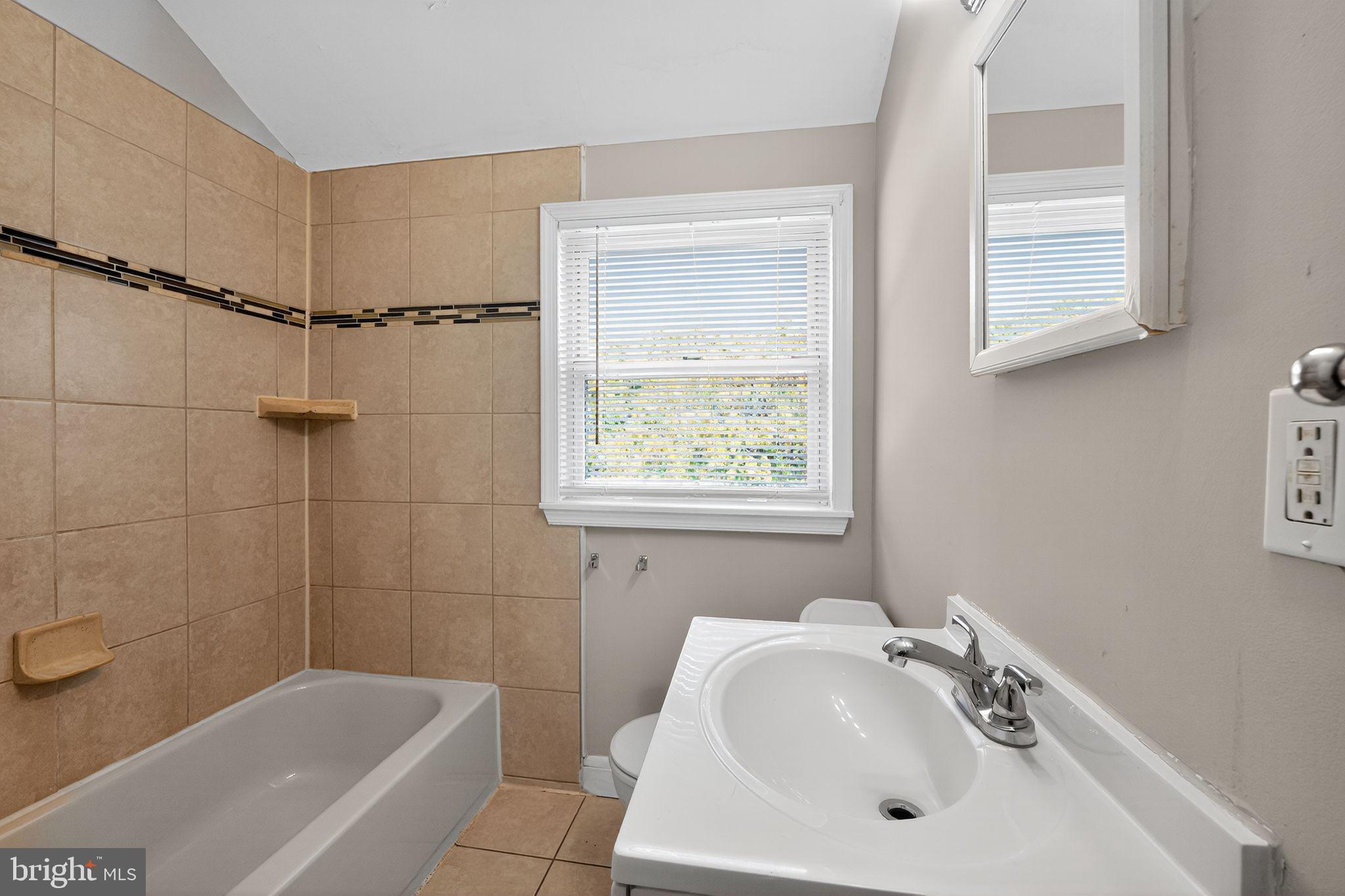 3125 Vulcan Road Dundalk, MD 21222 - Photo 26 of 33 a bathroom with a sink a window and shower